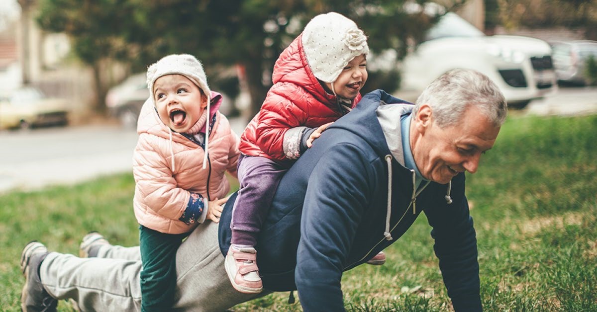 Grandfather carrying grandchildren
