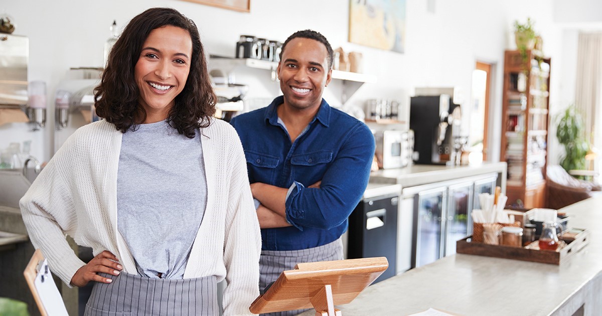 Business owners behind their counter