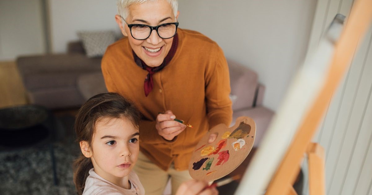 Grandmother painting with grandchild